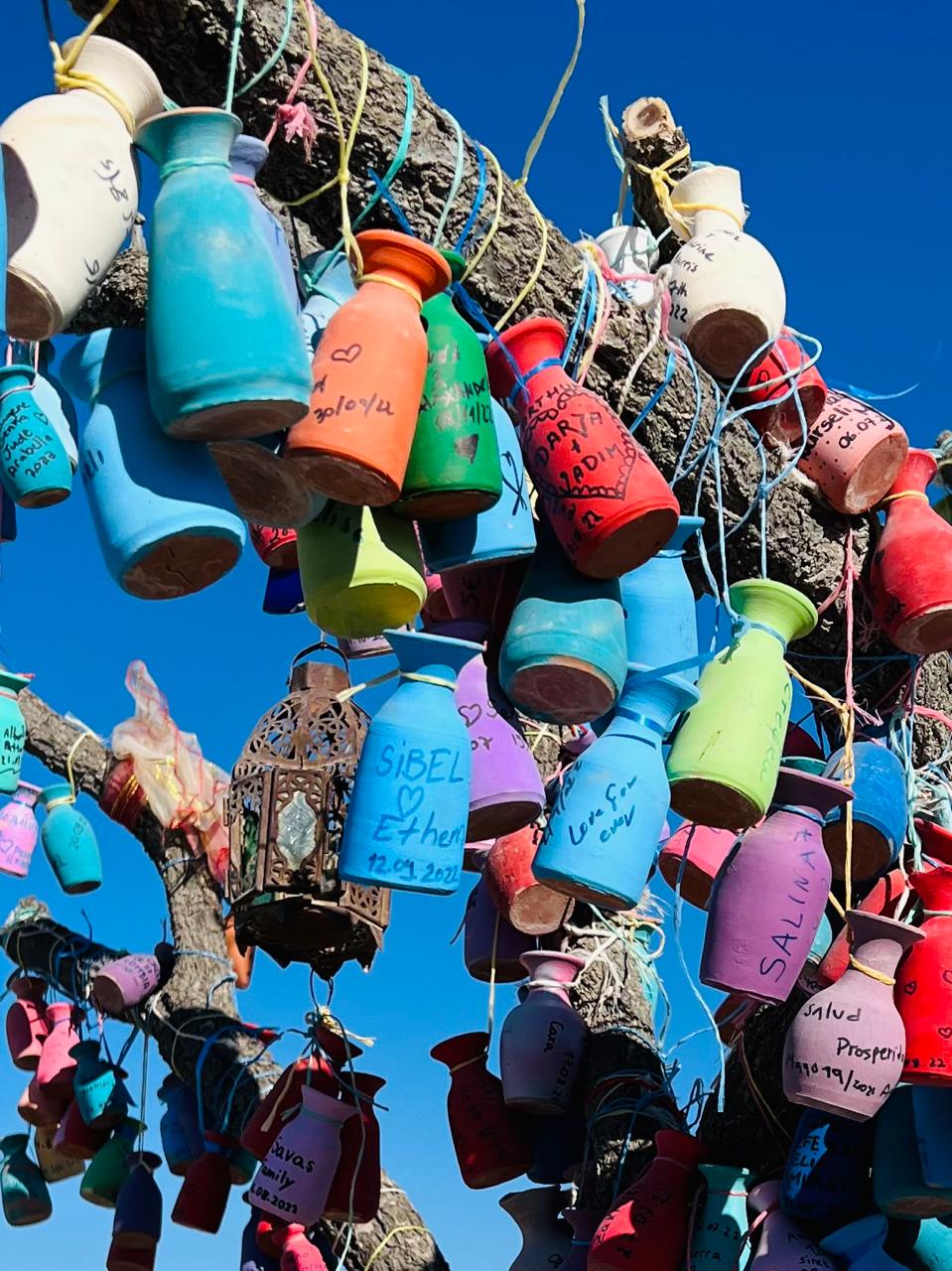 Message bottles hanging from beam.